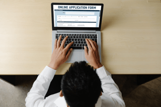 A Man filling out the Bahrain eVisa Application Form