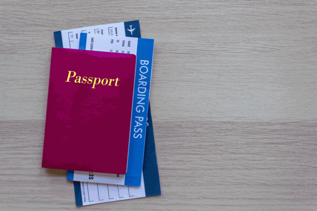 Passport and boarding pass on wood table