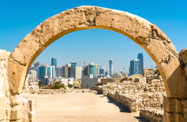 Bahrain Fort arch and Manama skyline
