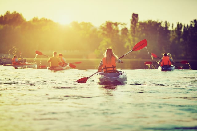 Family Kayaking Together On Water