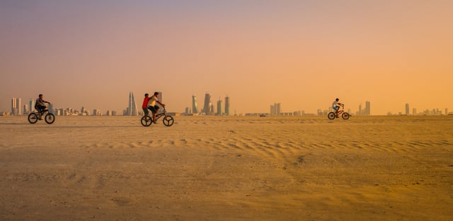 Kids riding bicycles in the Bahrain desert